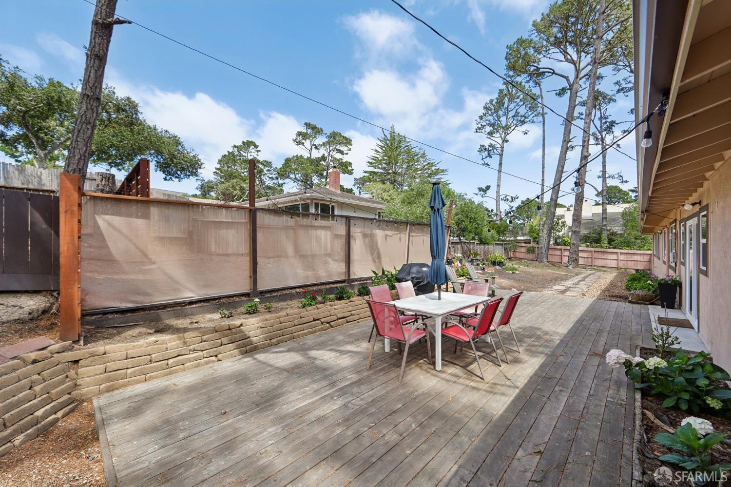 4052 Costado Road Pebble Beach, CA 93953 - Photo 31 of 35 a backyard of a house with wooden floor table and chairs