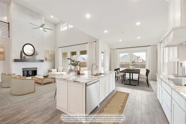 a living room with fireplace furniture and a large window