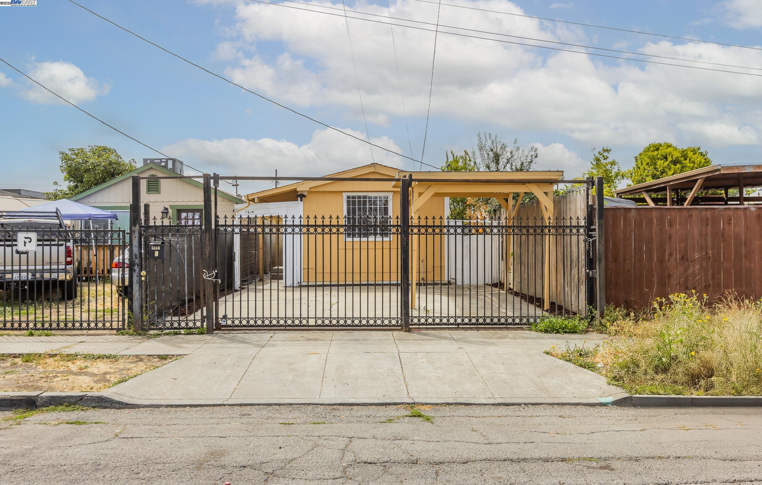 1216 88th Avenue Oakland, CA 94621 - Photo 1 of 1 a view of a brick house with a iron gate