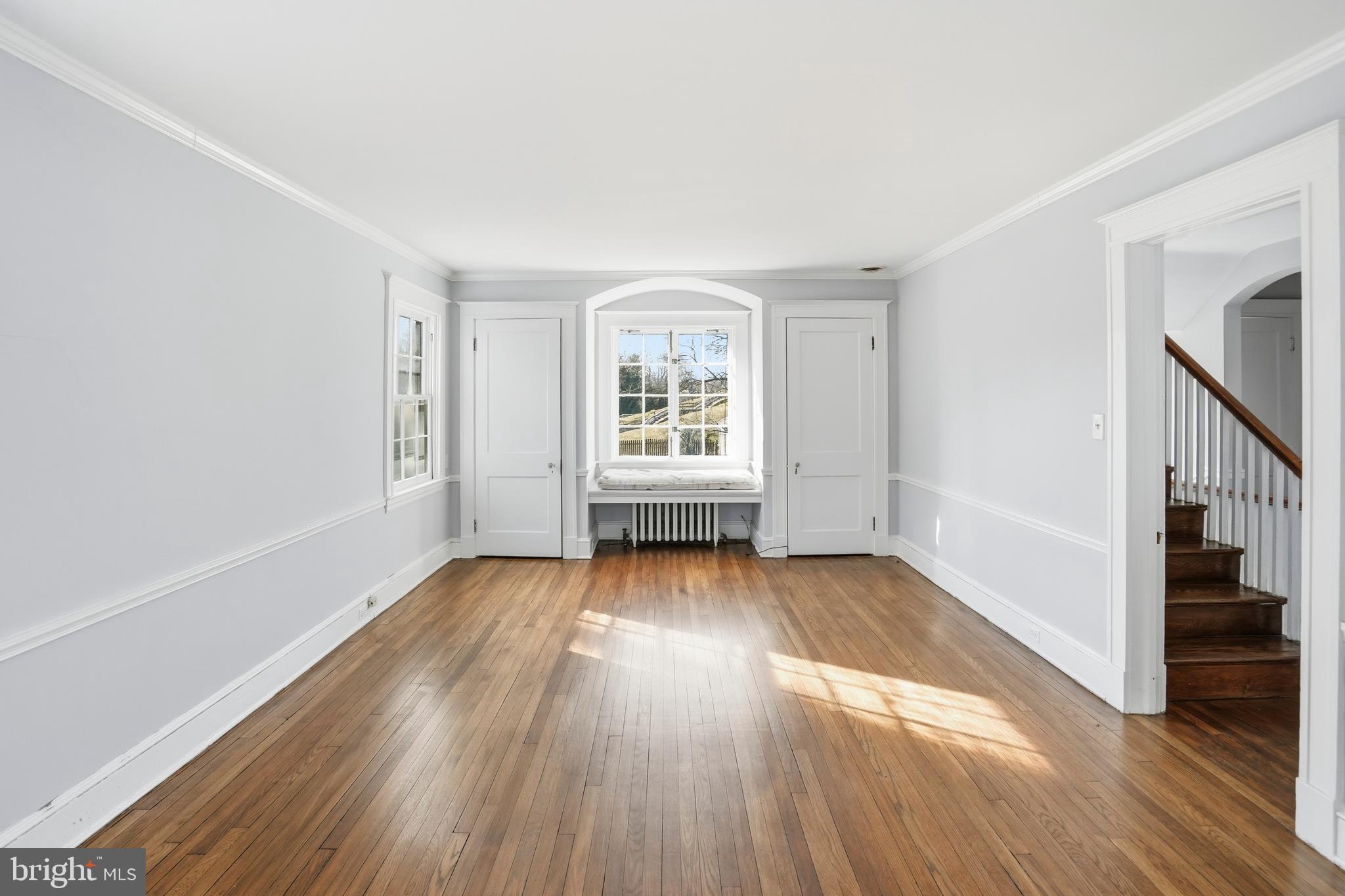 4416 Underwood Road Baltimore, MD 21218 - Photo 16 of 42 a view of an empty room with wooden floor and fan