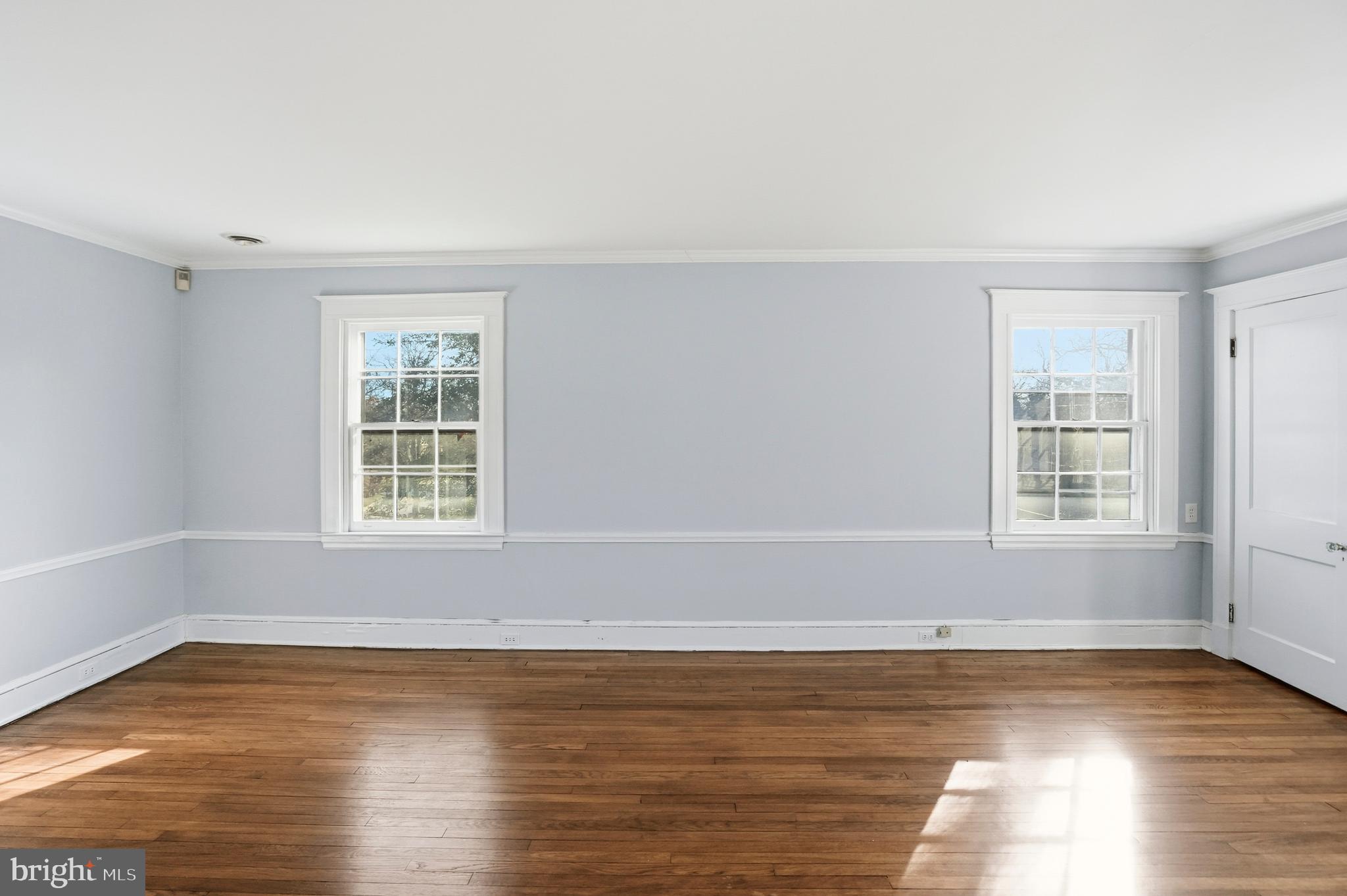 4416 Underwood Road Baltimore, MD 21218 - Photo 17 of 42 an empty room with wooden floor and windows