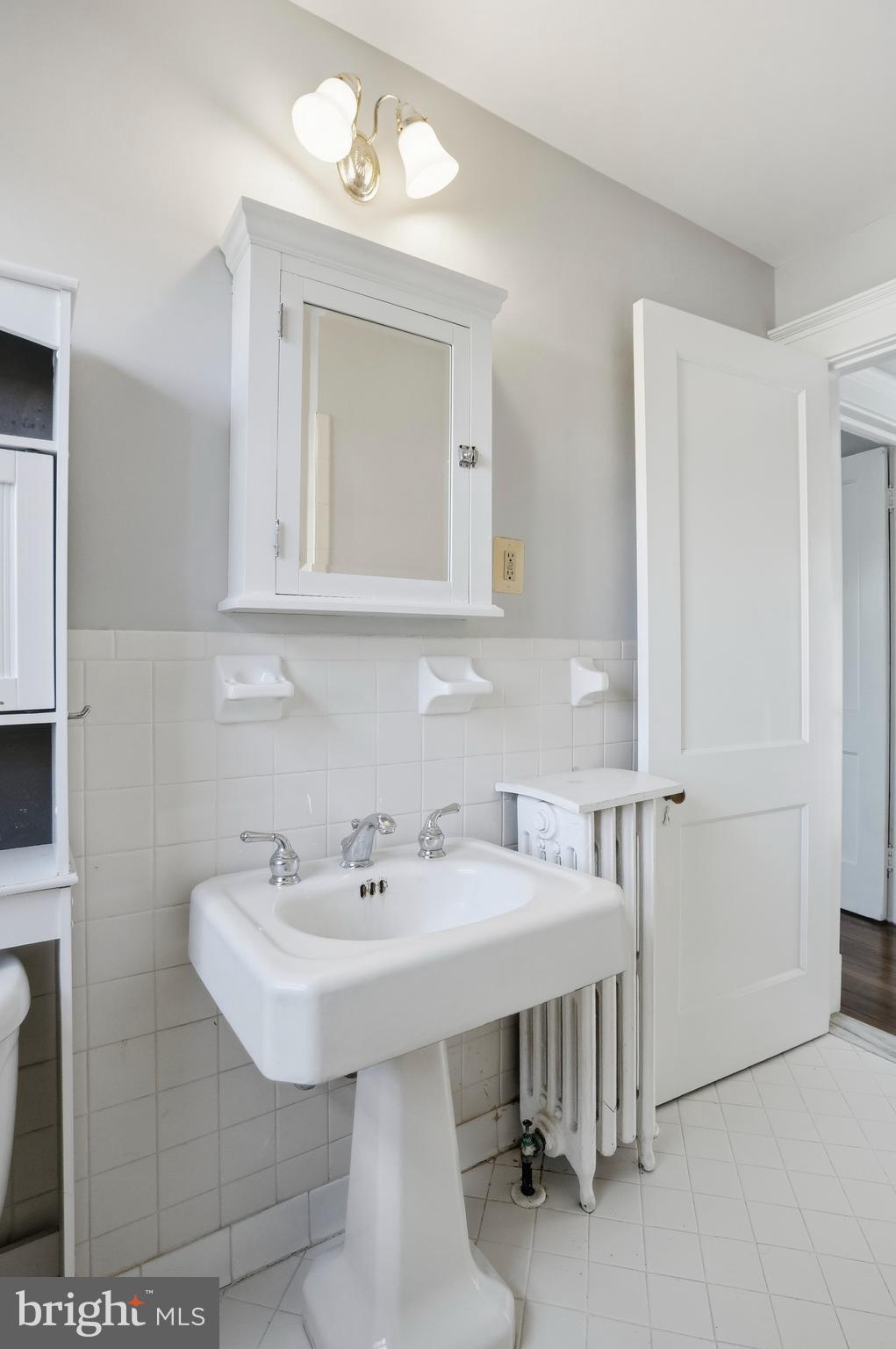 4416 Underwood Road Baltimore, MD 21218 - Photo 24 of 42 a bathroom with a sink and a mirror