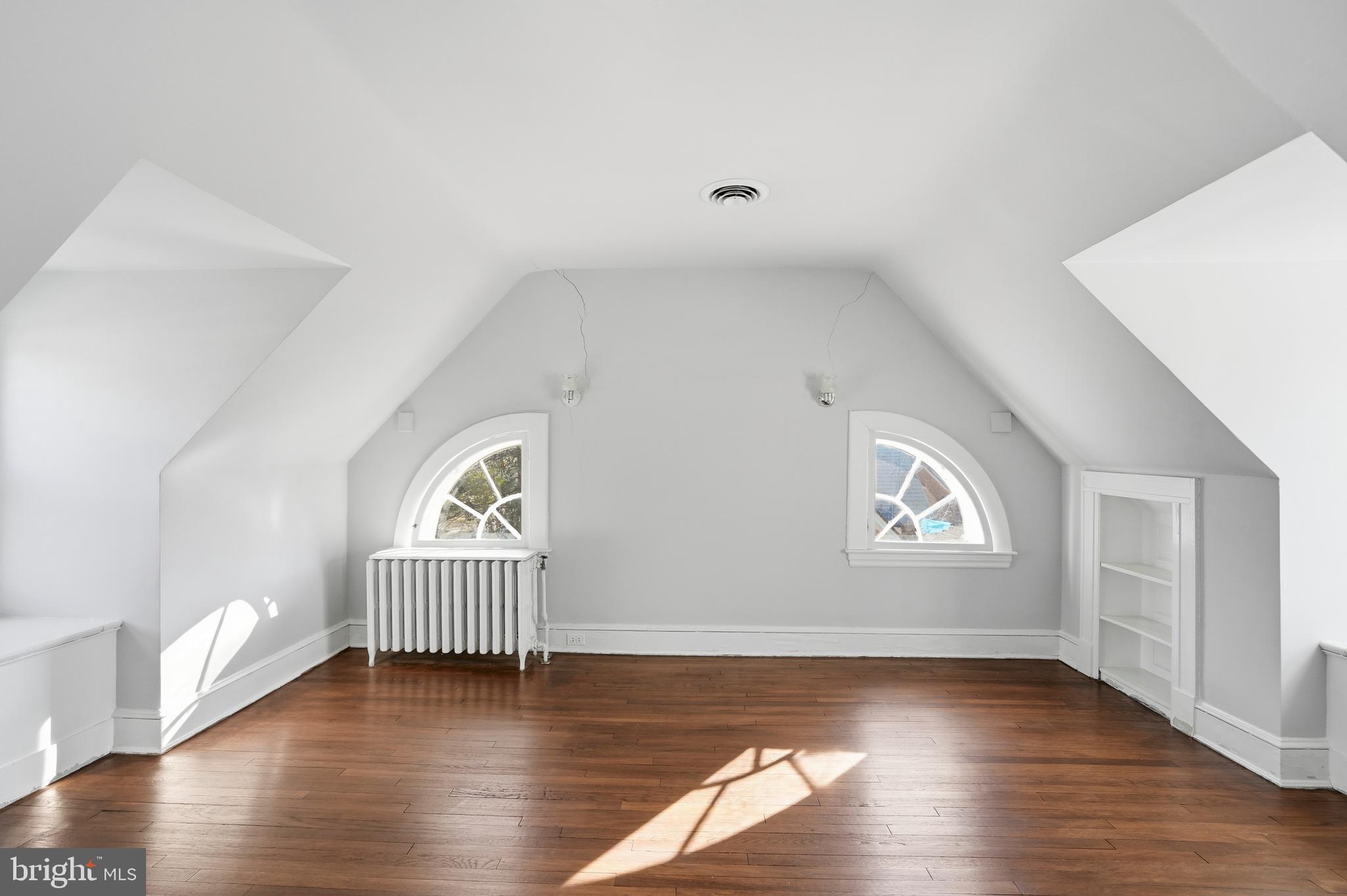 4416 Underwood Road Baltimore, MD 21218 - Photo 28 of 42 a view of an empty room with wooden floor and a window