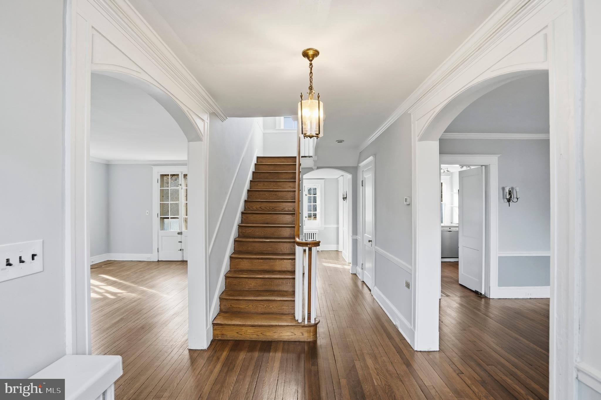 4416 Underwood Road Baltimore, MD 21218 - Photo 3 of 42 a view of a hallway with wooden floor and stairs