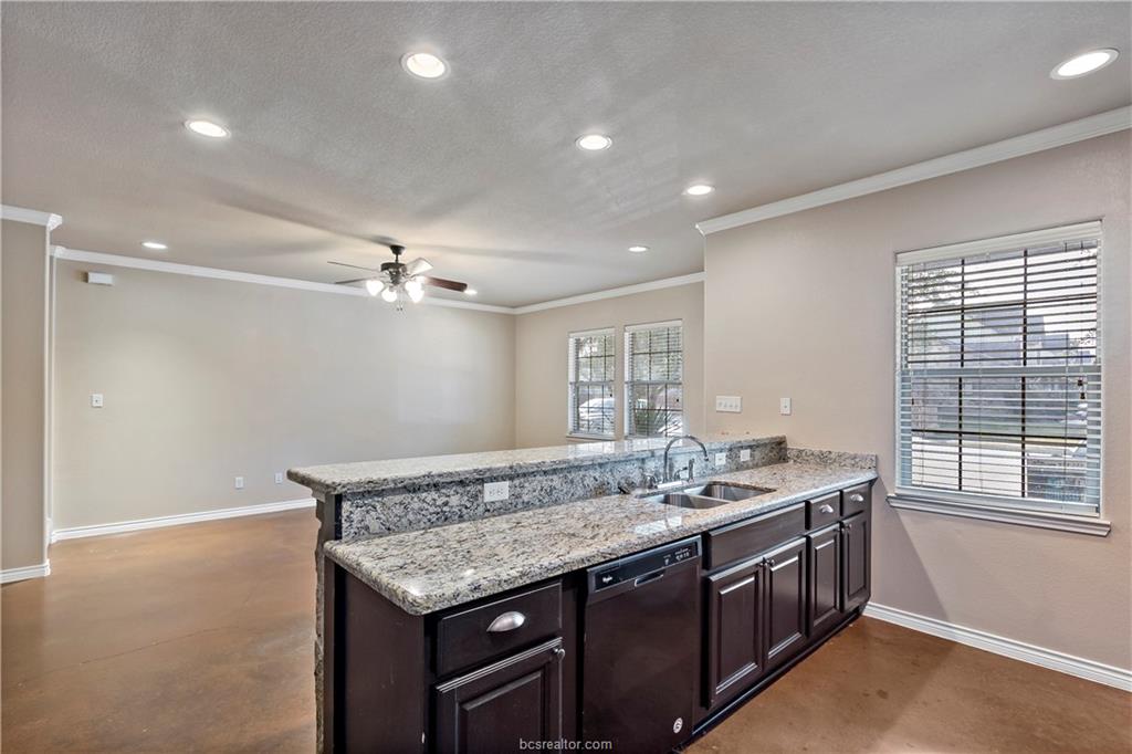 4295 Commando Trail College Station, TX 77845 - Photo 11 of 25 a bathroom with a granite countertop sink and a mirror