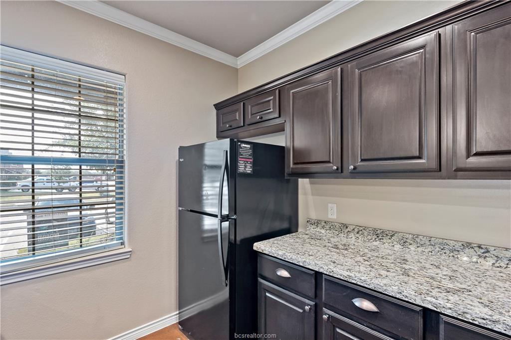 4295 Commando Trail College Station, TX 77845 - Photo 12 of 25 a kitchen with stainless steel appliances granite countertop a refrigerator and a sink