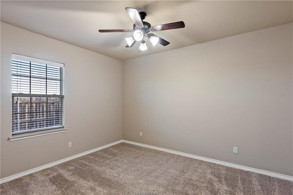 4295 Commando Trail College Station, TX 77845 - Photo 15 of 25 an empty room with chandelier fan and windows