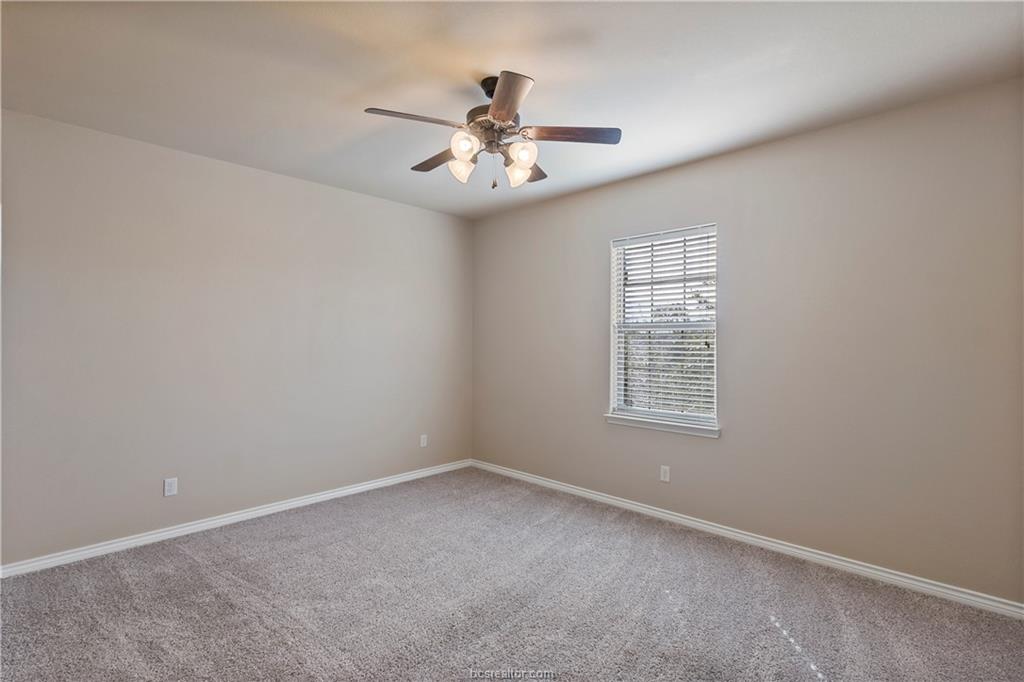 4295 Commando Trail College Station, TX 77845 - Photo 22 of 25 an empty room with windows and fan