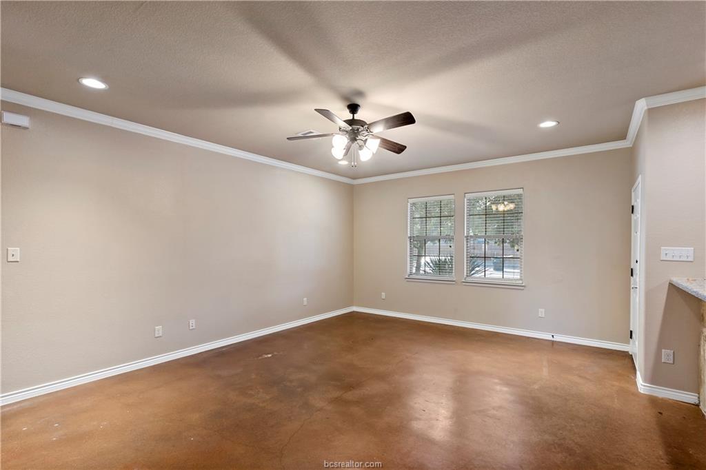 4295 Commando Trail College Station, TX 77845 - Photo 7 of 25 an empty room with windows and a ceiling fan