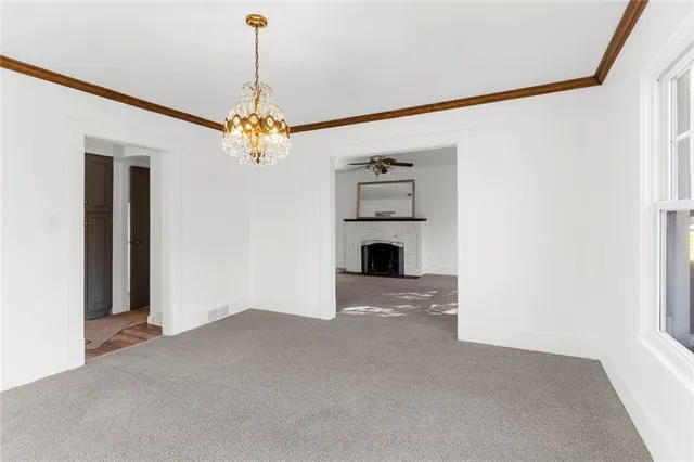 a living room with a fireplace and a painting on the wall