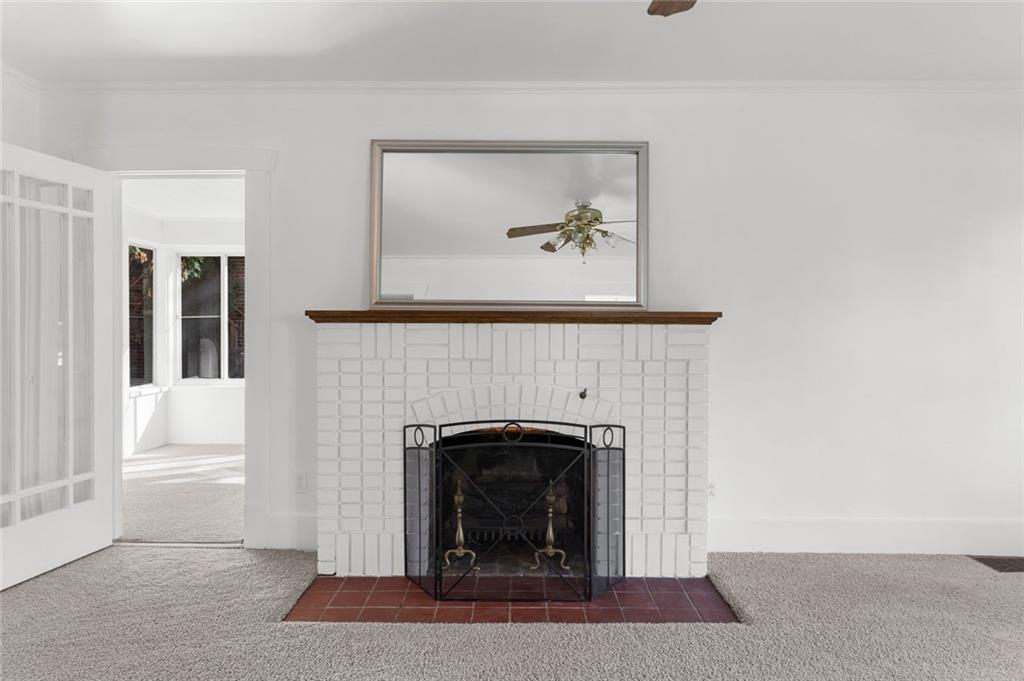 841 Highland Road Sharon, PA 16146 - Photo 15 of 39 a living room with a fireplace and a painting on the wall