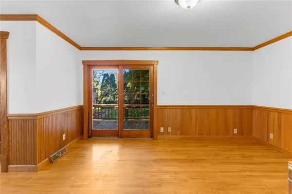 a view of a livingroom with wooden floor and furniture