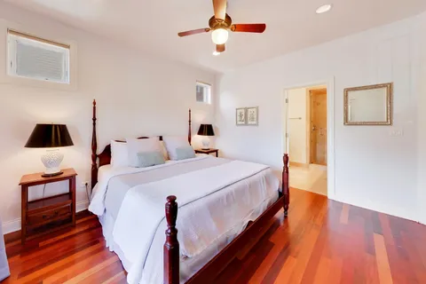 a bed room with a bed and wooden floor