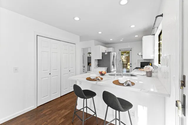a large kitchen with a table and chairs in it