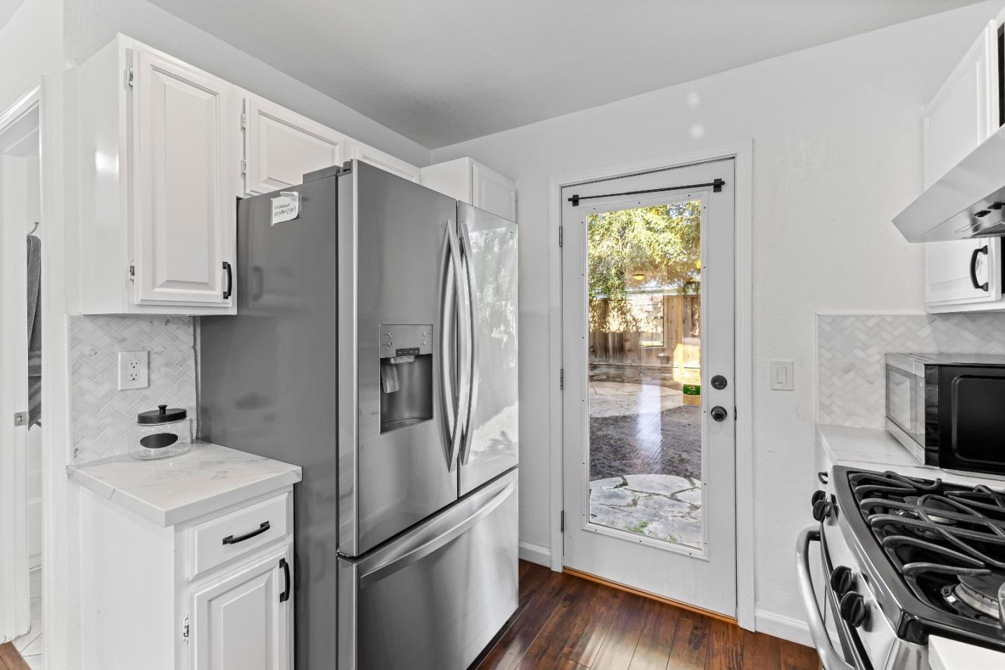 1165 Lerma Lane Gilroy, CA 95020 - Photo 11 of 37 a kitchen with stainless steel appliances a refrigerator stove and wooden floor