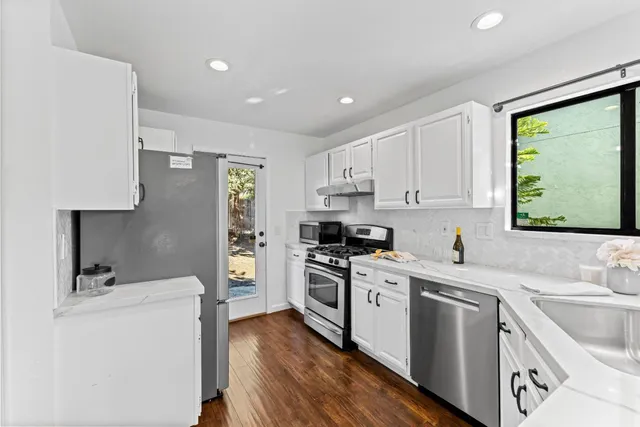 a kitchen with a sink stove and refrigerator