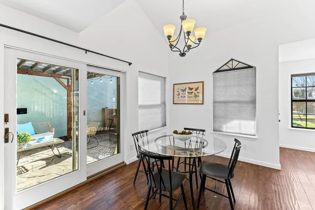 a view of a dining room with furniture wooden floor and a chandelier