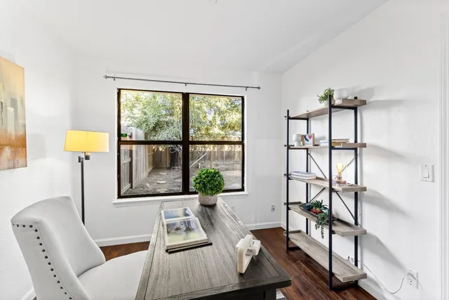 a view of a livingroom with furniture and a window