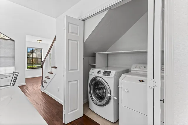 a view of a hallway with washer and dryer
