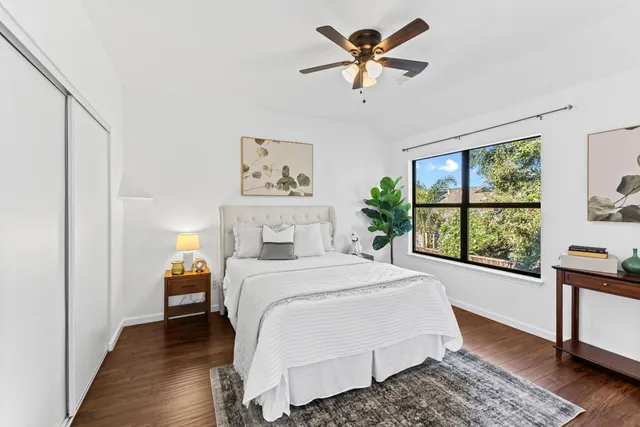 a bedroom with a large bed and a window