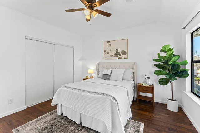 a bedroom with a bed and a potted plant