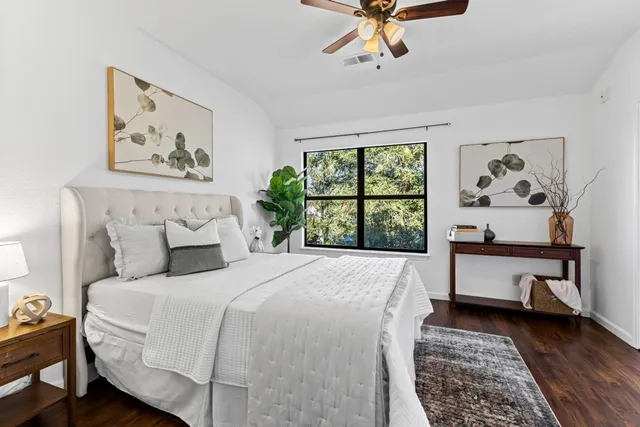 a bedroom with a large bed and a window