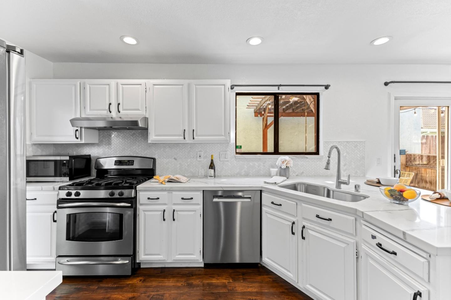 1165 Lerma Lane Gilroy, CA 95020 - Photo 5 of 37 a kitchen with a sink stove and cabinets