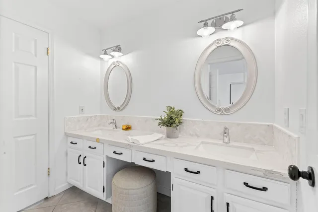 a bathroom with a double vanity sink double and mirror