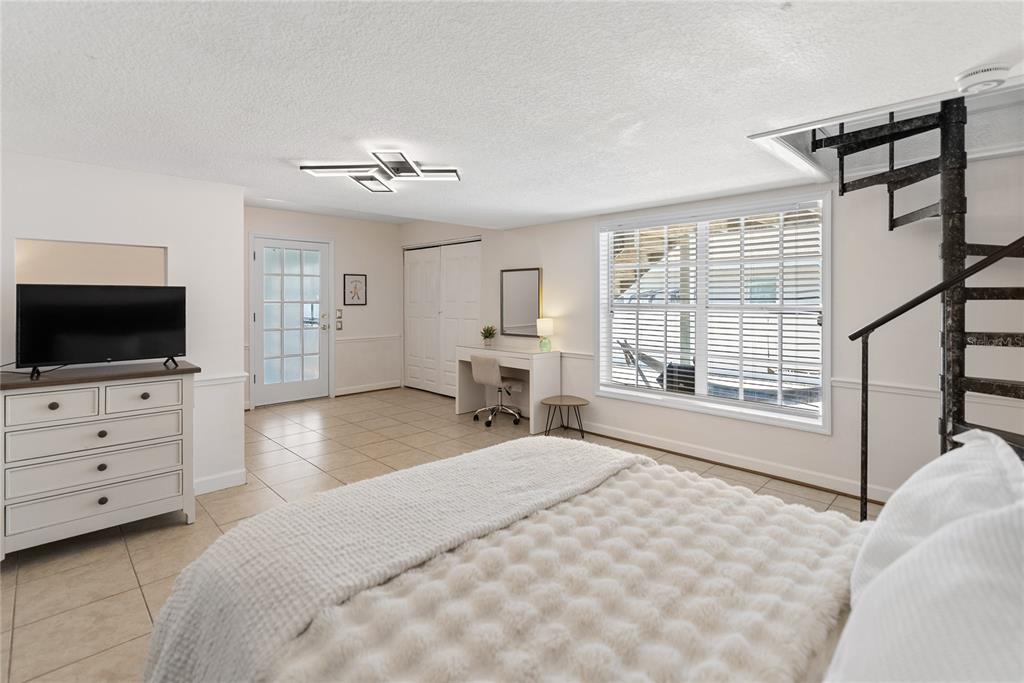 861 Nectar Road Venice, FL 34293 - Photo 27 of 75 a bedroom with a large bed and flat tv