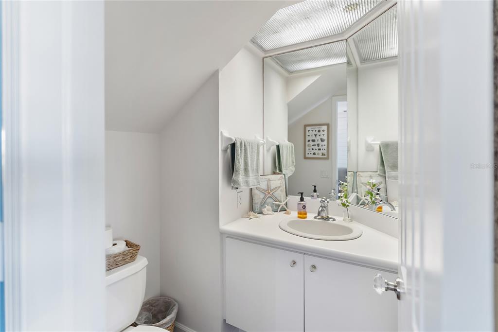 861 Nectar Road Venice, FL 34293 - Photo 28 of 75 a bathroom with a sink vanity and a mirror