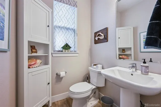 a bathroom with a sink toilet and a mirror