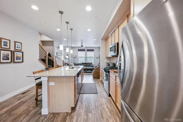 a view of a kitchen with cabinets and wooden floor