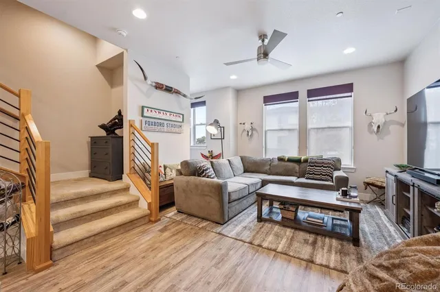 a living room with furniture and a wooden floor