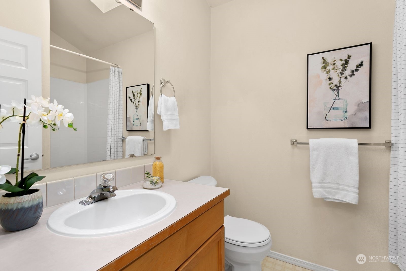 1522 196th Street Southeast, Unit C102 Bothell, WA 98012 - Photo 11 of 15 a bathroom with a sink a toilet and a mirror