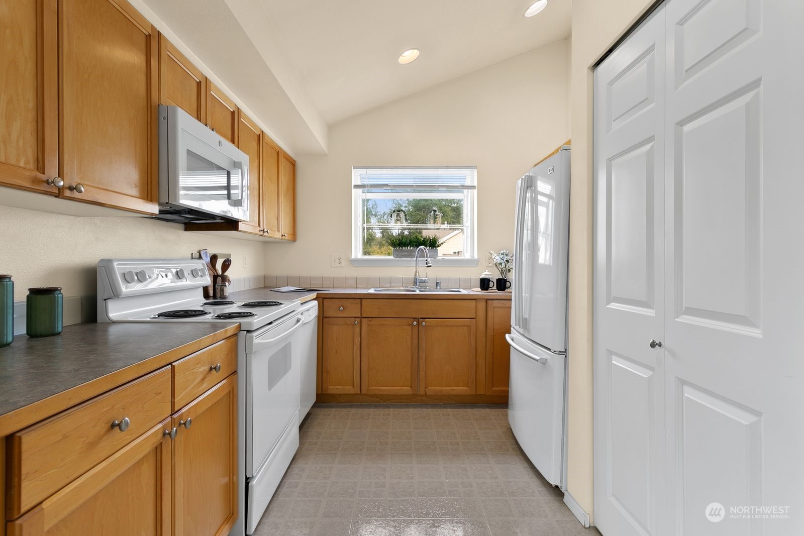 1522 196th Street Southeast, Unit C102 Bothell, WA 98012 - Photo 8 of 15 a kitchen with a sink stove and cabinets
