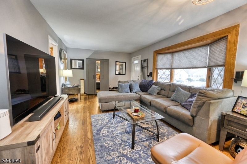 3313 Banta Road South Plainfield, NJ 07080 - Photo 5 of 13 a living room with furniture a flat screen tv and a large window