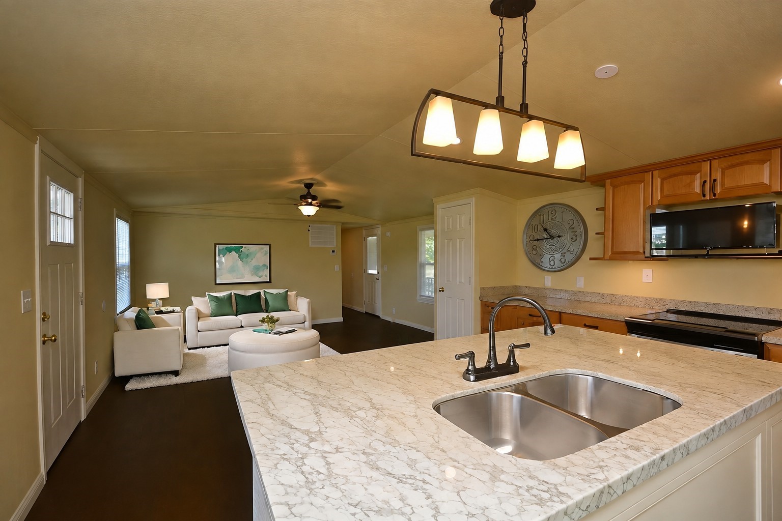 12652 Calvary Road Willis, TX 77318 - Photo 6 of 20 Spacious open-plan kitchen and living area featuring a large countertop island with a double sink, modern lighting, and cozy seating and a virtually staged living space.