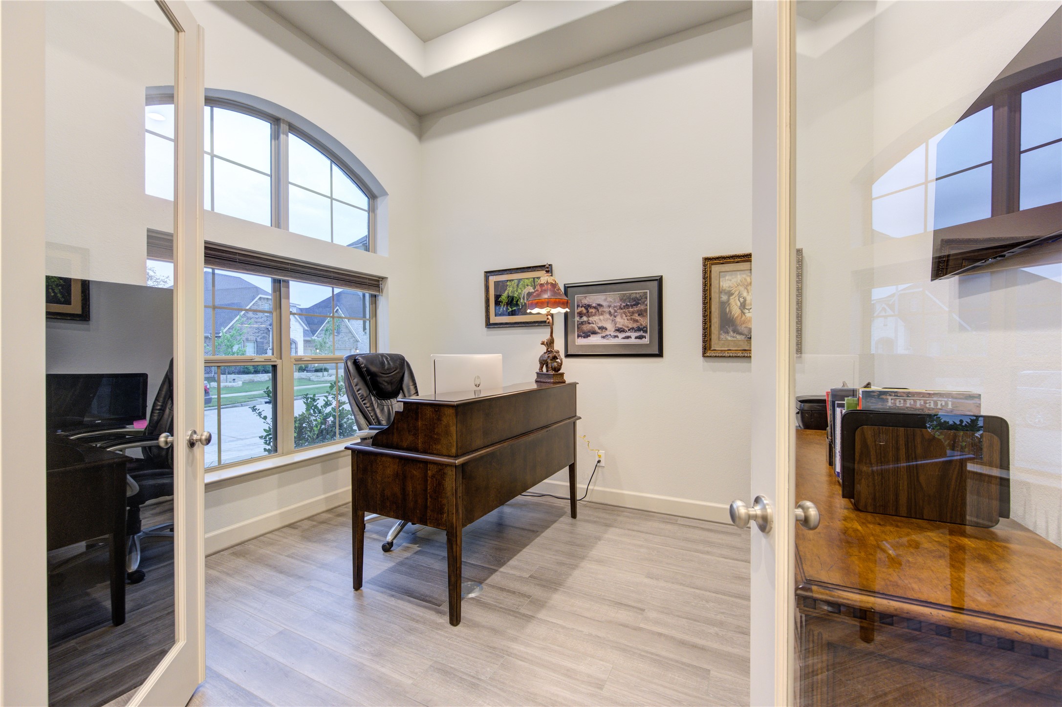 7326 Orangetip Road Katy, TX 77493 - Photo 7 of 43 Private Study with a View: Ideal for remote work, this dedicated home office features elegant French doors, built-in shelving, and large windows offering inspiring views of the front lawn.
