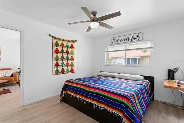 a bedroom with a bed and a window