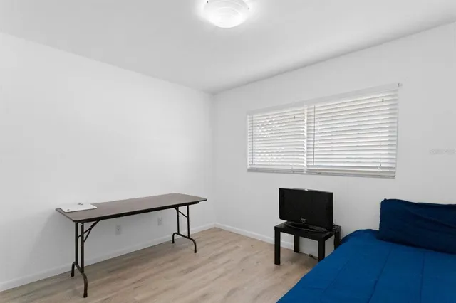 a view of a workspace with furniture and a window