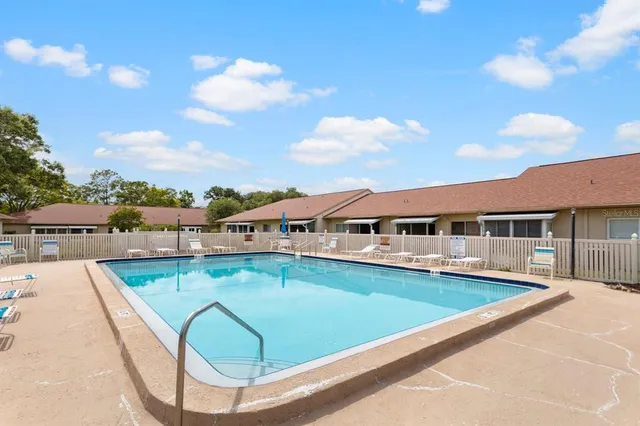 a view of a swimming pool with a lounge chair