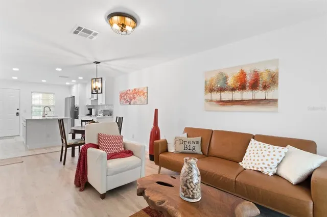 a living room with furniture and a night stand
