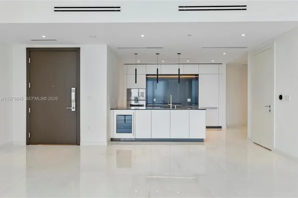 a kitchen with stainless steel appliances granite countertop a sink and a refrigerator