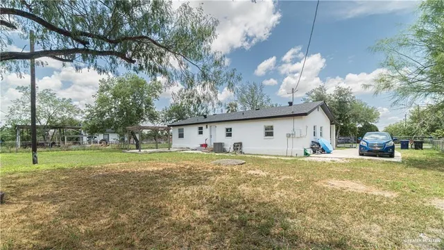 a view of a house with a yard and garage