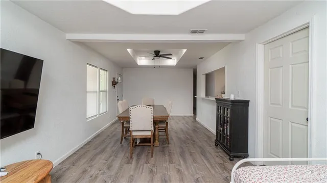 a view of a livingroom with furniture and a flat screen tv