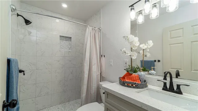 a bathroom sink a mirror and a shower