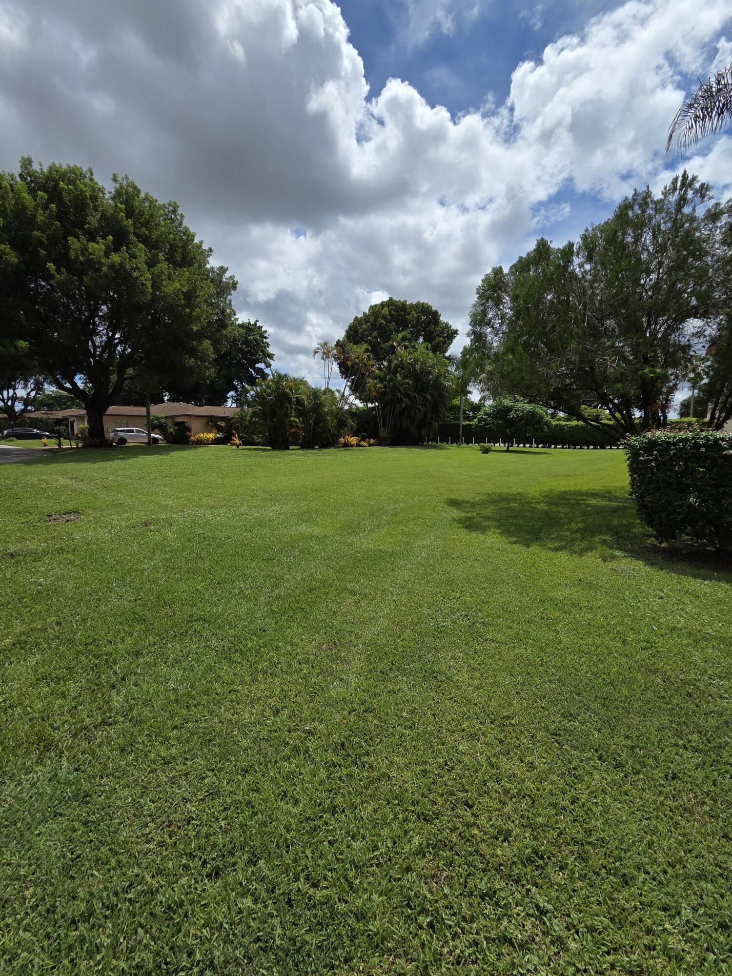 14790 Bonaire Boulevard, Unit 104 Delray Beach, FL 33446 - Photo 12 of 12 a view of field of grass and trees