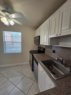 a kitchen that has a sink and a stove