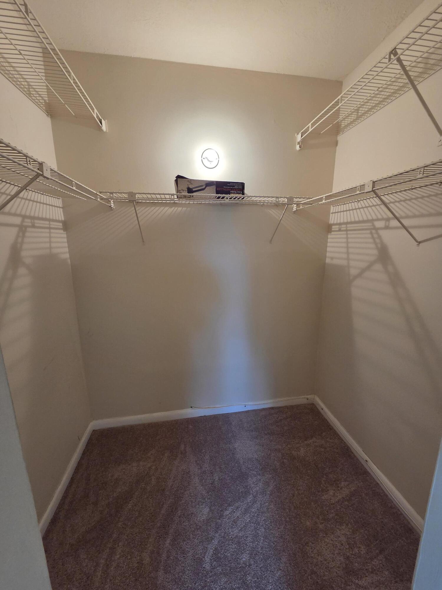 14790 Bonaire Boulevard, Unit 104 Delray Beach, FL 33446 - Photo 7 of 12 a view of a room with racks on the wall