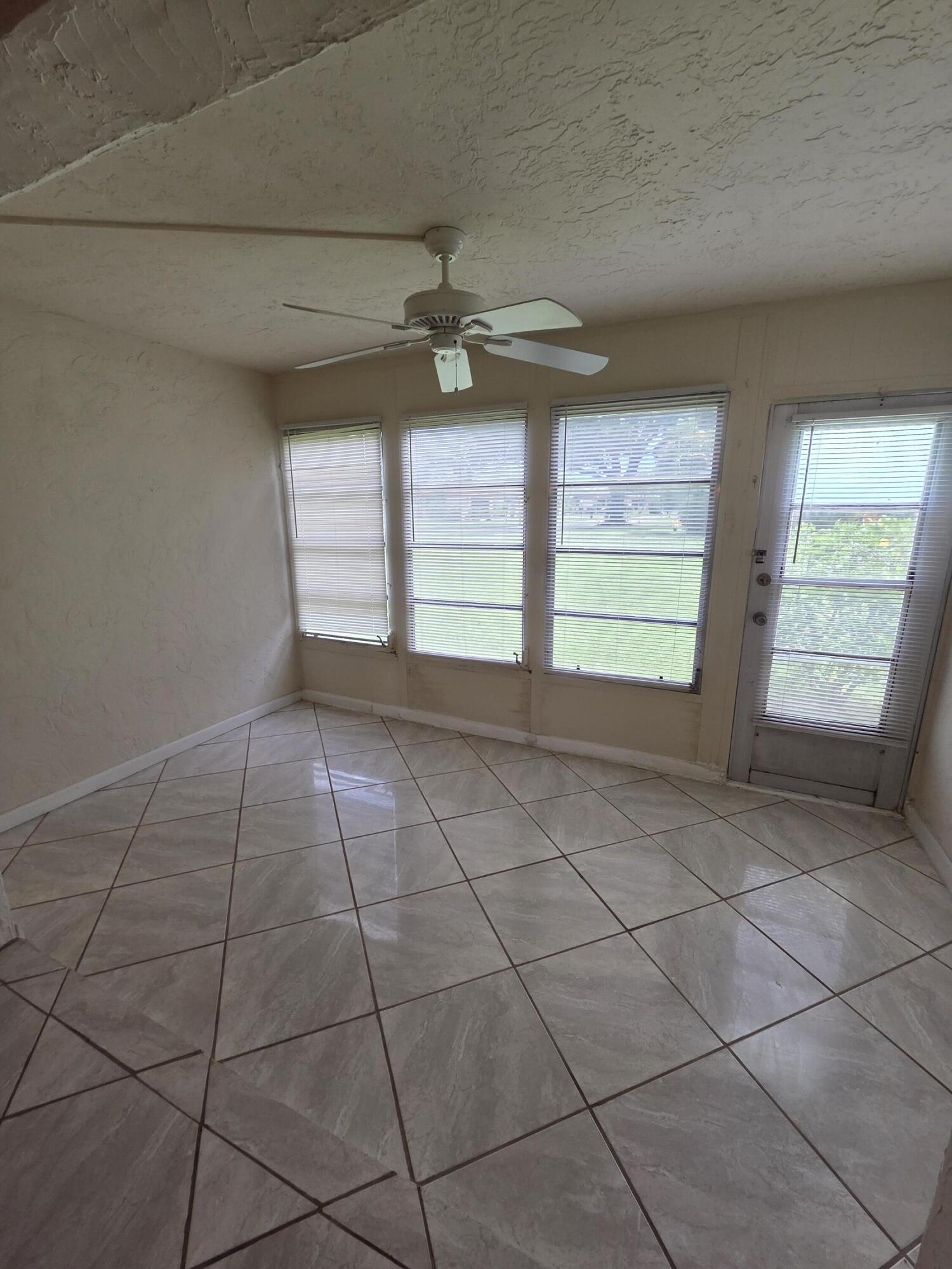 14790 Bonaire Boulevard, Unit 104 Delray Beach, FL 33446 - Photo 8 of 12 a view of an empty room with a window
